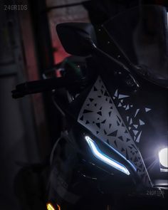 a close up of a motorcycle with its headlights on