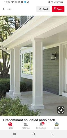 the front porch is covered with white pillars and columns that are lined up against the house's gray siding