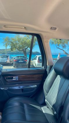 the interior of a car with several cars parked in front of it and one is looking out the window