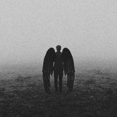 two people standing next to each other with wings on their backs in the foggy sky