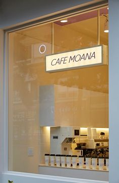 there is a sign in the window that says cafe moana on it's side