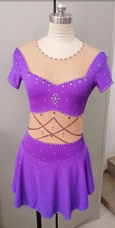 a woman's purple latin dance outfit on display