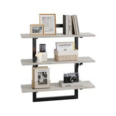 three shelves with pictures, books and other items on them in various sizes and colors