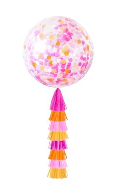 a large balloon with confetti and fringes on the top is floating in the air