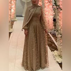 A Neutral-Toned, Long-Sleeved Dress With Delicate Gold Sequins, Worn Once And Made In Turkey. Features Balloon Sheer Sleeves And A High Collar For Added Elegance And Coverage, This Dress Exudes Sophistication With Its Simple Yet Refined Design For Hijabis. Can Fit For Sizes 4-6, Festive Long Sleeve Dresses With Sheer Sleeves, Eid Sequined Long Sleeve Gown, Eid Sequin Long Sleeve Gown, Long Sleeve Mother Of The Bride Dress For Banquet, Long Sleeve Maxi Dress For Eid Banquet, Formal Evening Dress For Eid, Long Sleeve Gown For Eid Banquet, Long Sleeve Dresses For Eid Banquet, Eid Banquet Gown With Long Sleeves