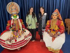 three women standing next to each other in costume