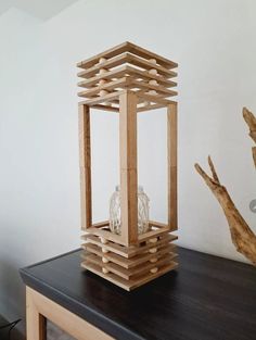 a wooden lantern sitting on top of a table