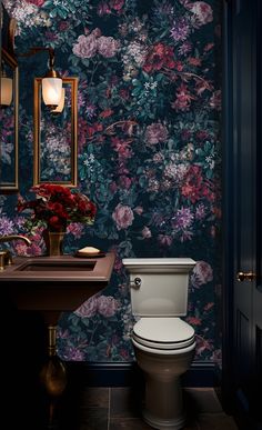 a toilet and sink in a room with floral wallpaper