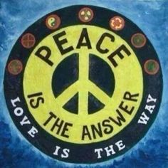 a peace sign painted on the side of a blue and yellow background with words above it