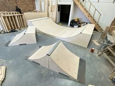 several skateboard ramps are being constructed in a building