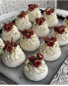 there are many small desserts with strawberries on top