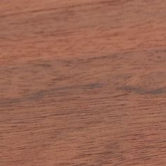 a small bird sitting on top of a wooden table