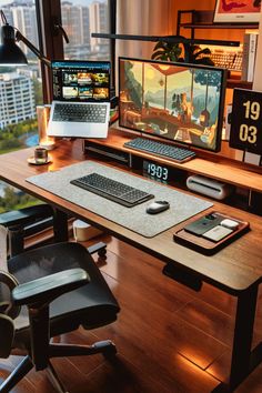 a computer desk with two monitors and a laptop on it in front of a window