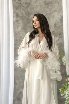 "Long bridal robe is made of high-qualiry silk satin. It has long wide sleeves made of lace and wide belt.  Boa natural  feathers! When you have one of the most important days in your life, everything should be perfect! You probably planned every minute of this day and now you are ready to make it real. The perfect day starts from the very morning which will be remembered every time you will look at your photos.  The bride robe should be beautiful and comfortable at the same time so you could en Long Bridal Robe Nordstrom, Luxury Floor-length Wedding Robe, Robe For Her, Luxury Long Sleeve Wedding Robe, Luxury Floor-length Robe For Wedding Night, Champagne Dressing Gown Fluffy Robe, Luxury Elegant Robe For Formal Occasions, Luxury Chic Wedding Robe, Luxury White Formal Robe