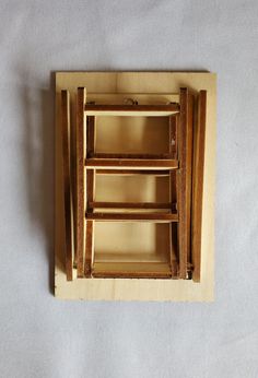 an unfinished wooden shelf with three shelves on each side and one drawer in the middle