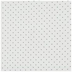 a white wall with black dots on it