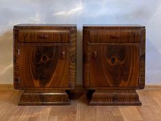 two wooden nightstands sitting side by side on top of a hard wood floor next to each other