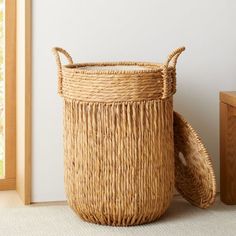 a basket sitting on the floor next to a window