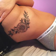 a woman's stomach with a flower tattoo on her belly and the words, calm heart