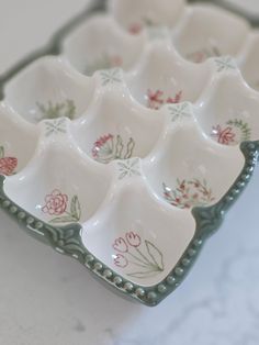 an assortment of white dishes with flowers on them