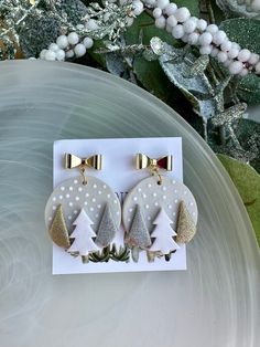 two white and gold christmas tree earrings with bows