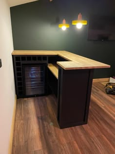 an empty room with wood flooring and dark green walls is pictured in this image