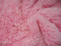 a pink fuzzy blanket is laying on the floor