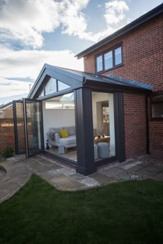 a house with a glass extension to the outside