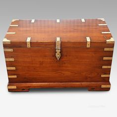 an antique wooden trunk with brass trimmings