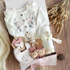 a baby's first birthday gift box with teddy bears, cookies and other items