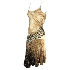 Presenting a stunning beige silk Roberto Cavalli slip dress. From the early 2000s, this gorgeous dress is covered in a tan abstract and leopard print. The dress features a scoop neckline, spaghetti straps, a flared hem, and a draped accent at the back. This sexy is constructed of luxurious silk that perfectly and gently reflects light. Approximate measurements: Size - S Bust: 24-26" Waist: 24" Hips: 28-30" Shoulder to hem: 50" 100% Silk Animal Print Slip Dress, Silk Dress With Leather Jacket, Slip Dress Jacket, Slip Dress Outfit Y2k, Dress Aesthetic Vintage, Dresses 2000s, Vintage Designer Dresses, 2000s Dresses, Frat Party Outfit