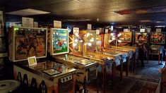 several pinball machines lined up in a room