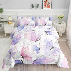 a bed with purple and pink butterflies on it