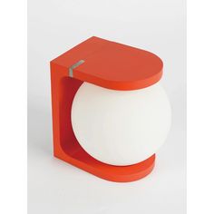 an orange and white object on a white surface with a red top around the edge