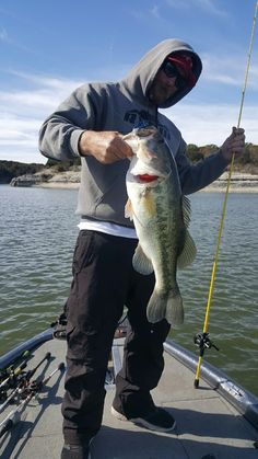 a man on a boat holding a large fish