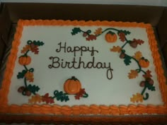 a birthday cake with the words happy birthday written on it and pumpkins, leaves and acorns