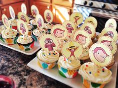 cupcakes with monkey faces on them are sitting on plates in front of an oven