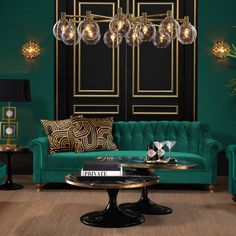 a living room with green couches and gold accents