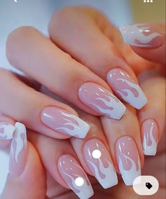 a woman's hands with white and pink nail polishes on their fingertipss