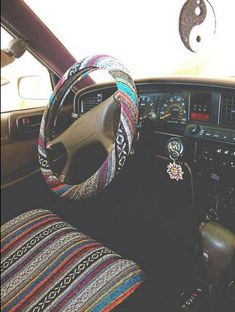 the interior of a car with steering wheel and dash stickers on it's dashboard