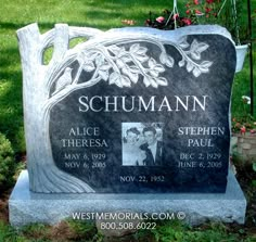 the headstone of two people in front of a tree with flowers and vines on it