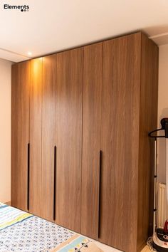 a bedroom with a bed and wooden cupboards