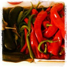 red peppers and green peppers in a box