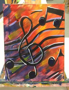 a painting with music notes painted on it's sides and in the background is an easel