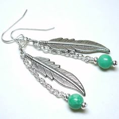 the earrings are made with silver and green beads