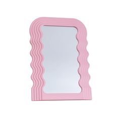 a pink mirror sitting on top of a white wall