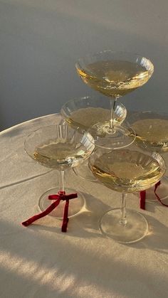 four wine glasses sitting on top of each other