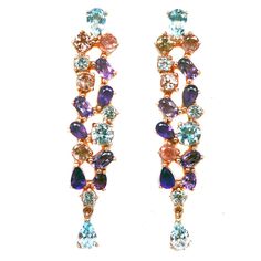 Sumptuous Retro-Elegant Long Earrings These lavish earrings feature all natural gemstones: Sky Blue Topaz, Amethyst & Tourmalines, pear & round cut, measuring between 3mm to 4x6mm. The face of each earring is 10.8x51mm.  They're 2 inches long and the total carat weight is a whopping 42ct! The setting is 18k rose gold over pure sterling silver.  They have pushback closures for pierced ears. This unique find is from an historic estate in Detroit, Michigan, where the pioneers of the auto industry l Fine Jewelry Teardrop Multi-stone Earrings, Multicolor Multi-stone Drop Jewelry, Blue Topaz Multi-stone Earrings, Amethyst Multi-stone Drop Earrings, Purple Multi-stone Dangle Earrings, Sky Blue Topaz, Gatsby, 18k Rose Gold, Long Earrings