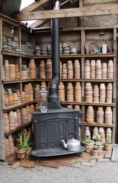 an old fashioned stove sitting in front of wooden shelves