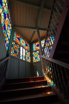 stairs leading up to stained glass windows in a church